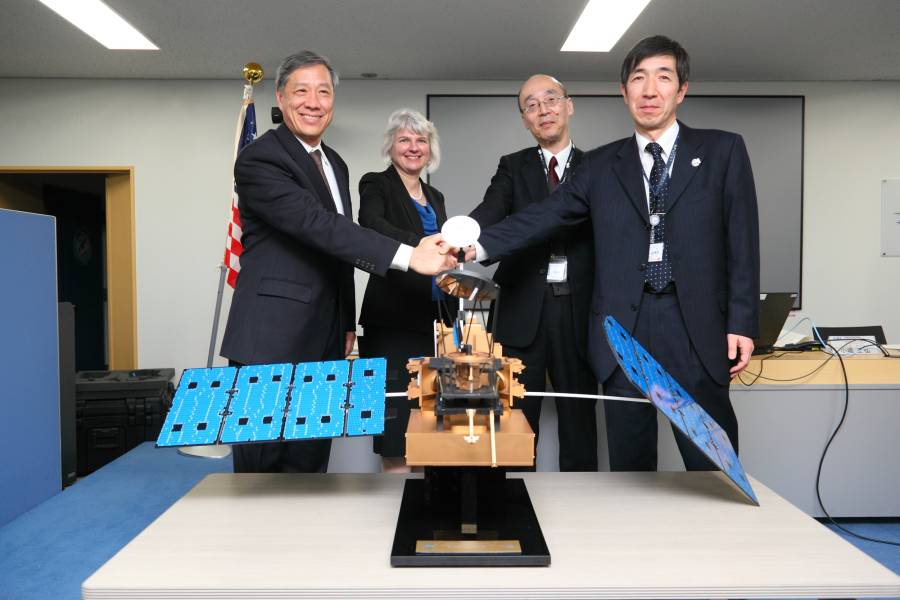 GPM Leads at the JAXA DPR Press Release, standing behind a model of the GPM Core