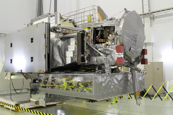 The GPM spacecraft oriented for inspections after its arrival in the clean room at Tanegashima Space Center.